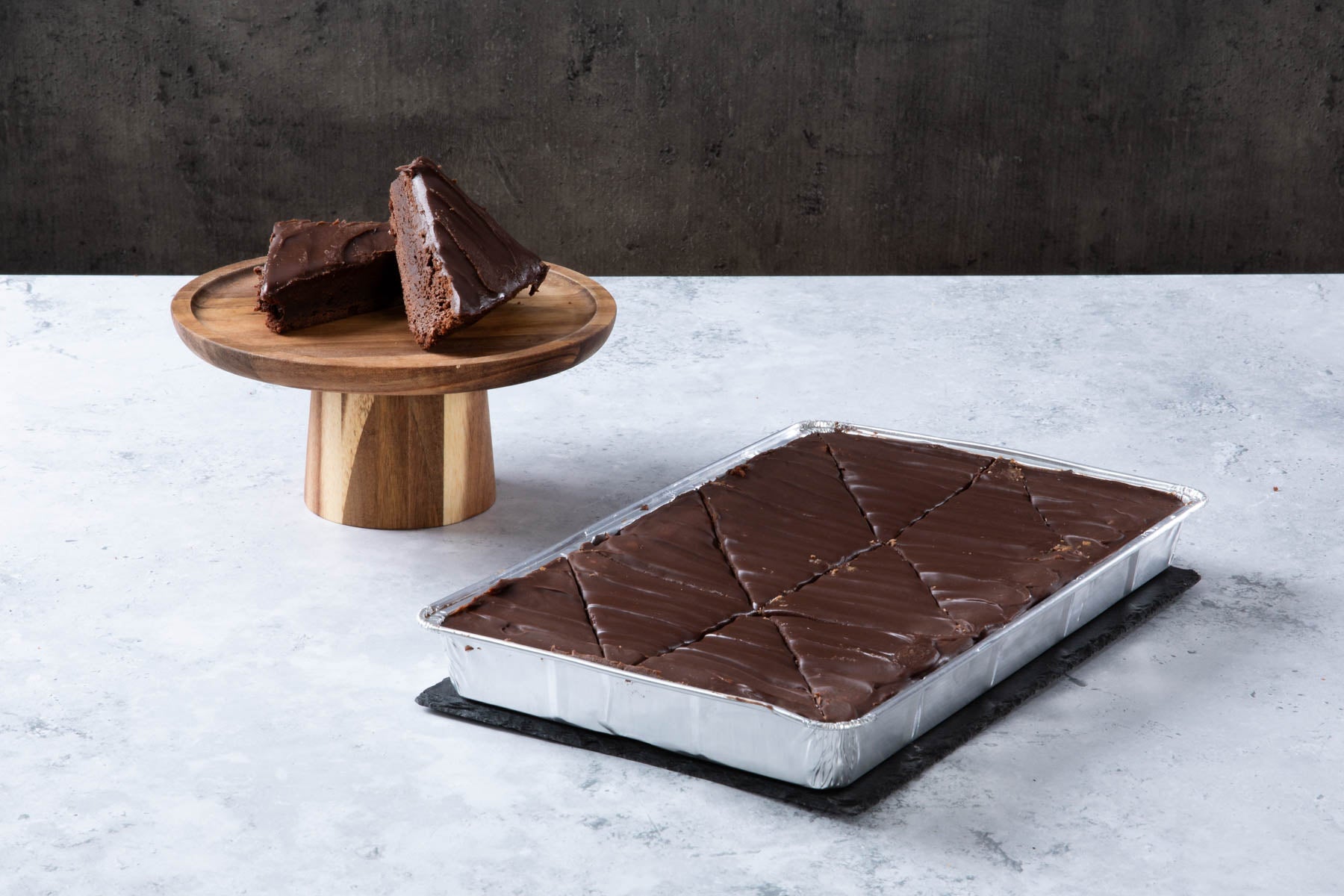 LHMC004-280.jpg Chocolate fudge cake slices with chocolate frosting in a baking tray.