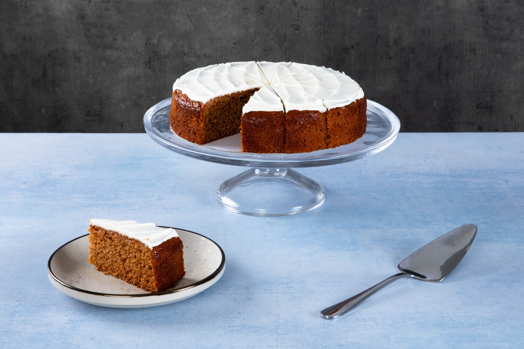 LHMC008-246.jpg Chocolate cake with creamy frosting and chocolate topping on a wooden board.