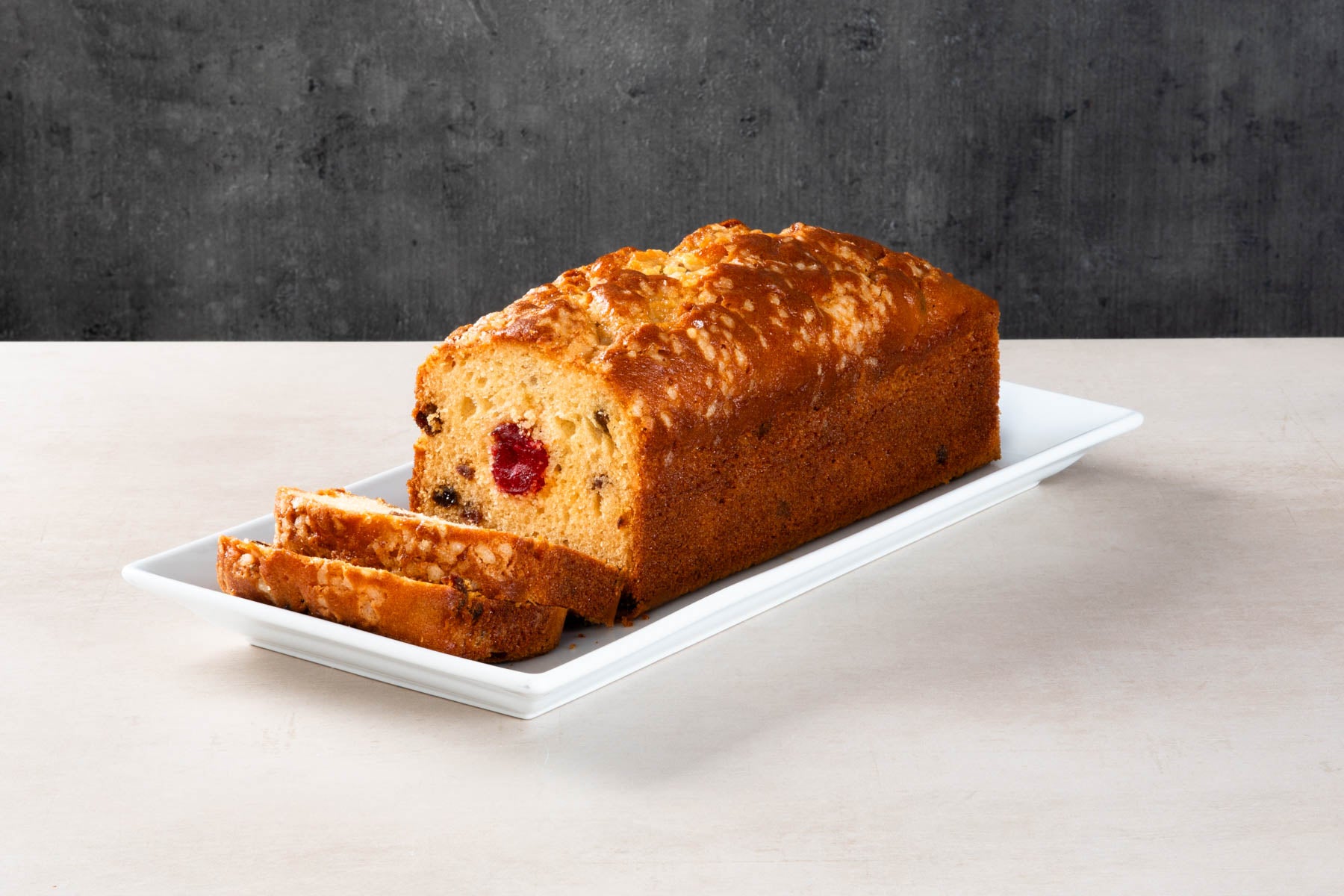 LHMC008-466.jpg Sliced fruit and cherry loaf cake with glazed crust