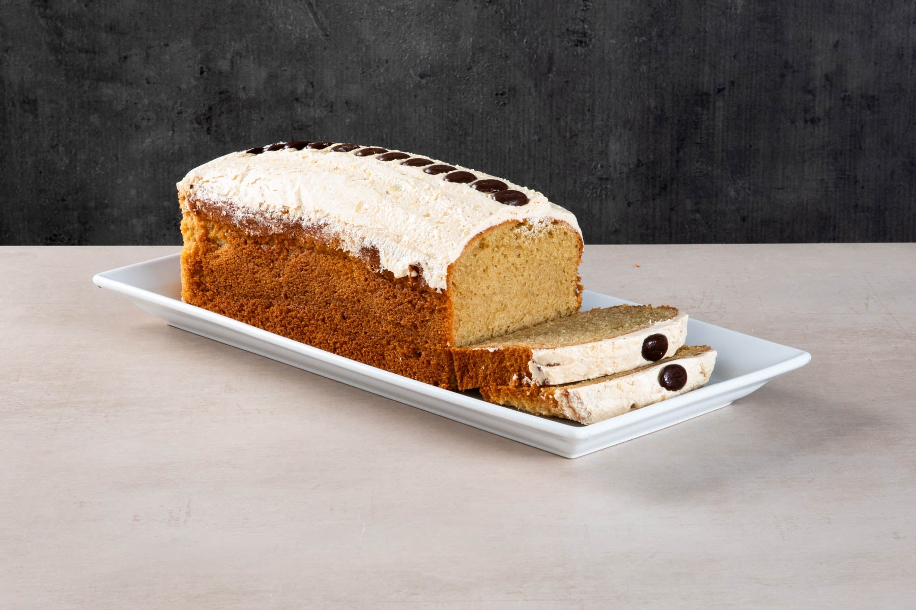 LHMC008-490_0c3e2b84-cf4a-48a0-afa3-421573b4fa1e.jpg Sliced coffee loaf cake with buttercream and chocolate buttons